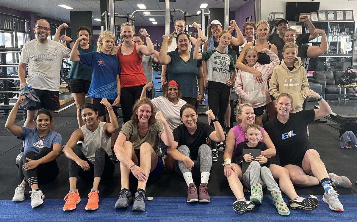 large group of people in a gym post workout