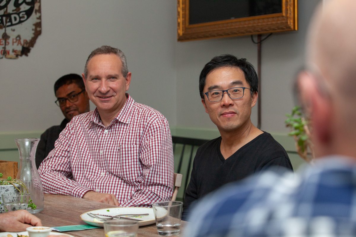 Men sitting at a table smiling