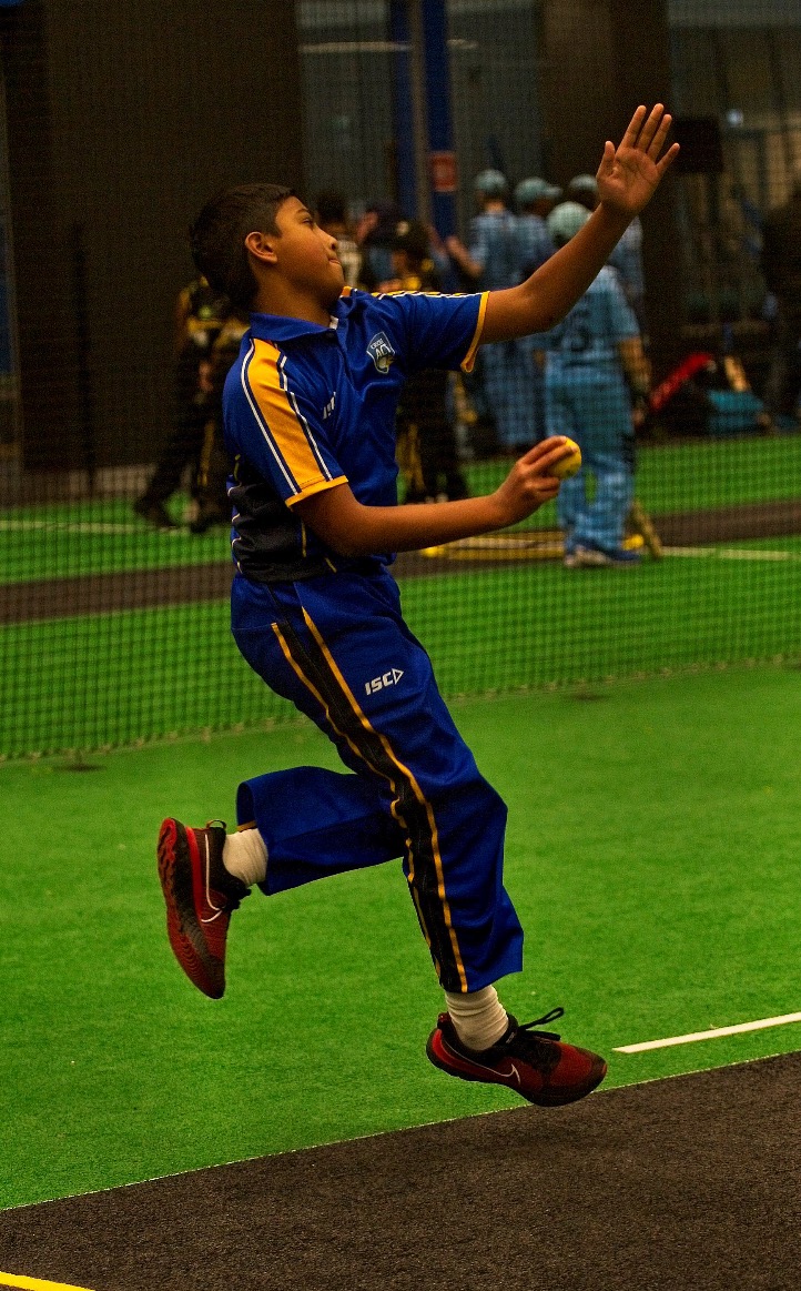 Young cricketer bowling