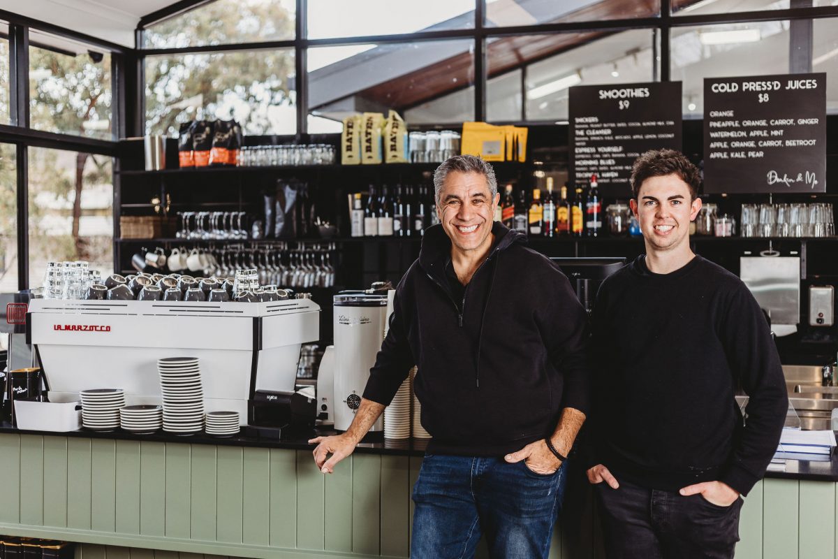 Two men standing in a cafe