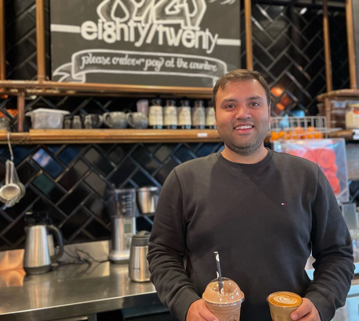 Man holding a coffee and a frappe 