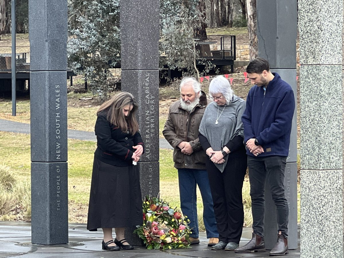 WorkSafe ACT commissioner Jacqueline Agius lays a wreath in memory of beloved Ben Catanzariti who was killed in 2012 with his dad Barney, mum Kay and brother Jack.
