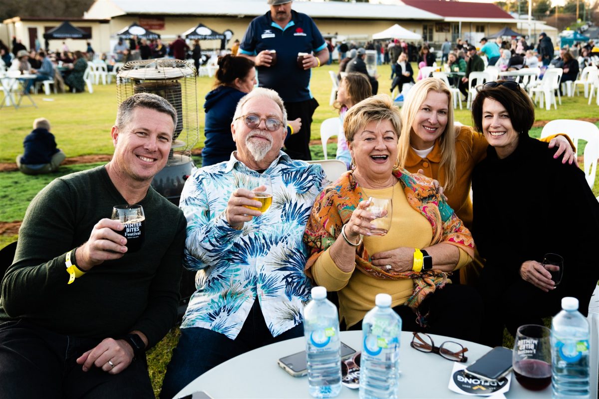 Four people sitting and drinking wine and cider