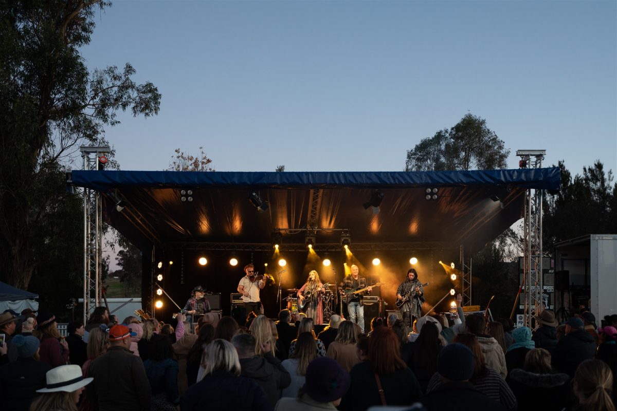 Band plays on stage for a crowd