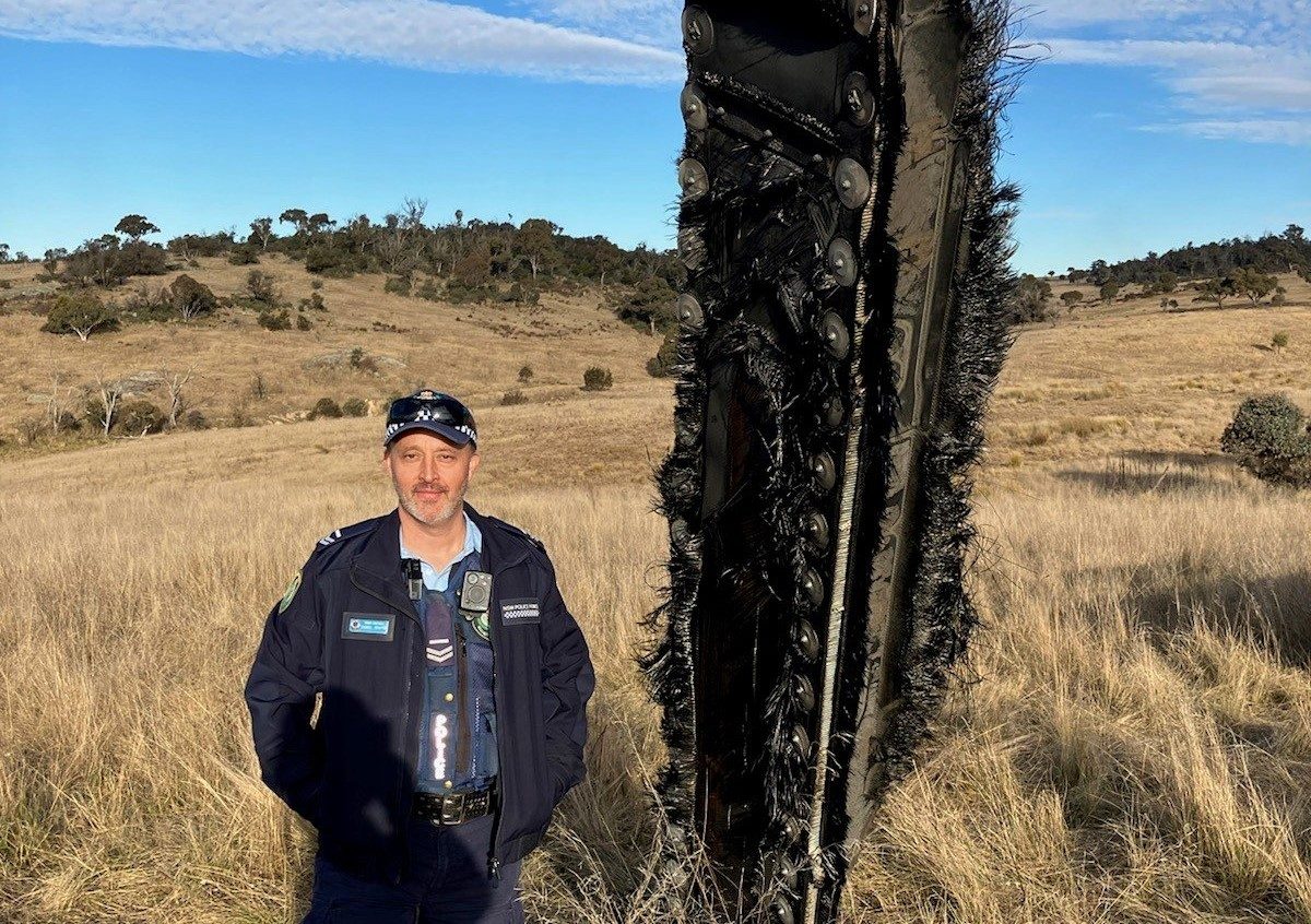 Police officer next to space junk