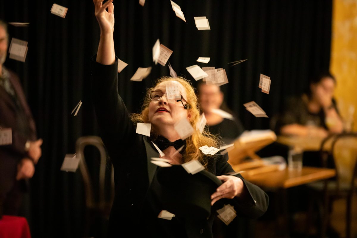 Music teacher Dianna Nixon with pieces of paper flying around her