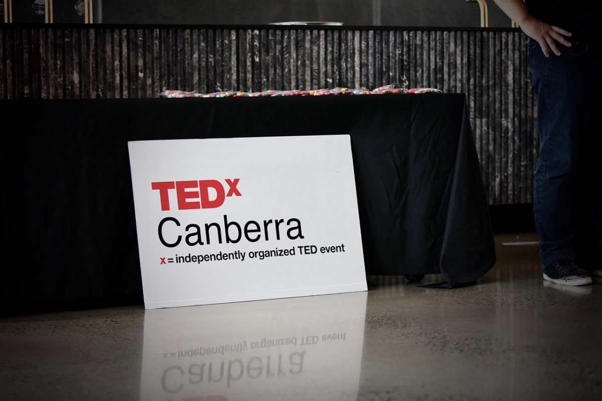 TEDxCanberra sign leaning against a table