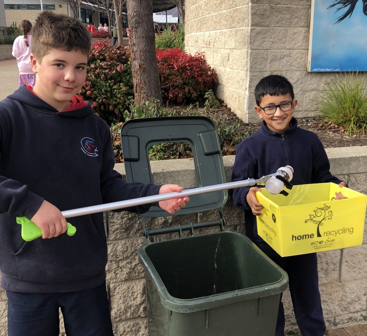 two students and a bin