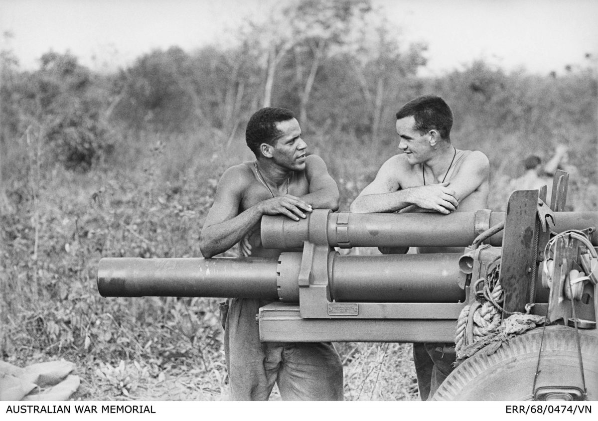 Two soldiers next to a Howitzer.