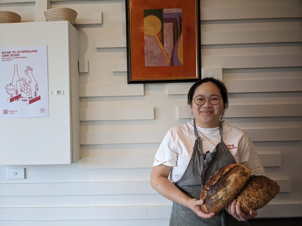 Woman holding loaves of bread