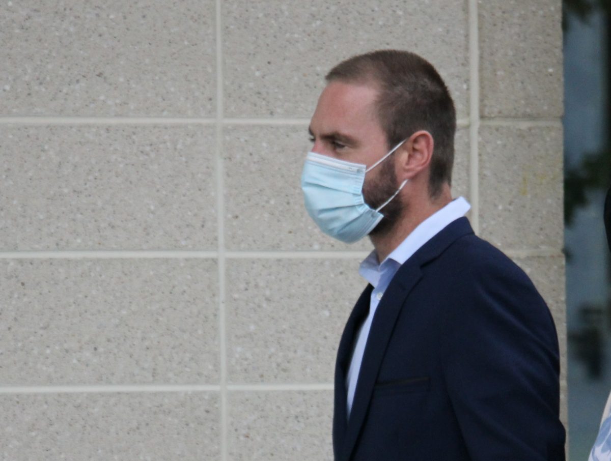 Man with mask leaving court