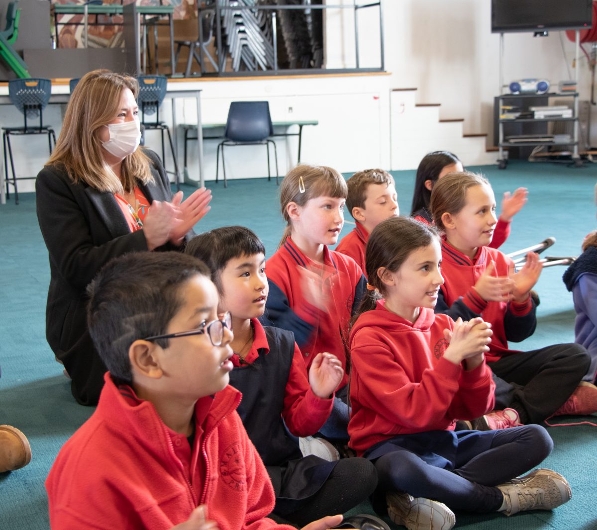 Minister for Education Yvette Berry with a group of Majura Primary School students enjoying a music lesson