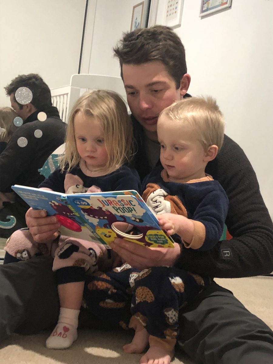 Man reading book to children