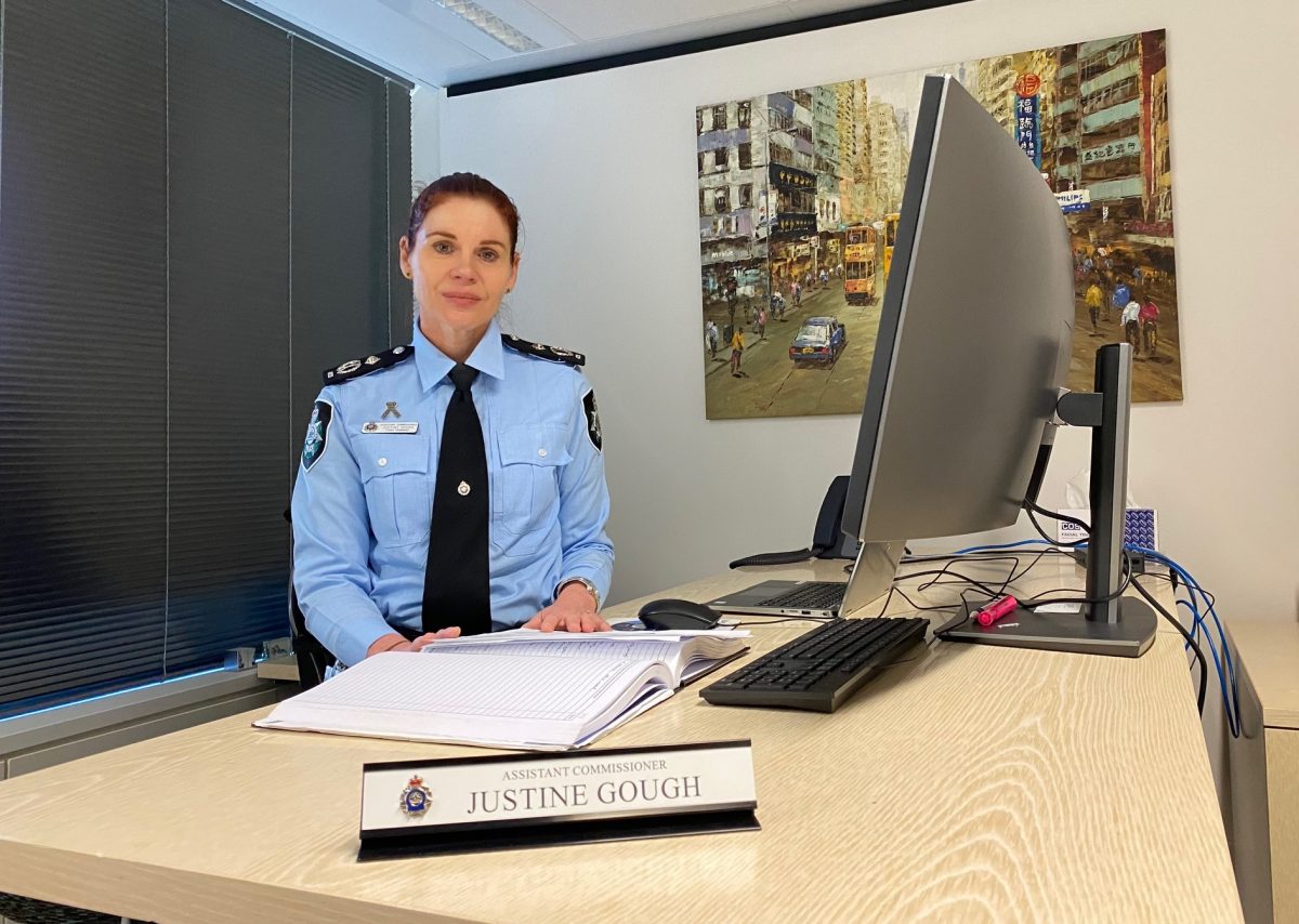 Woman in uniform sitting at a desk