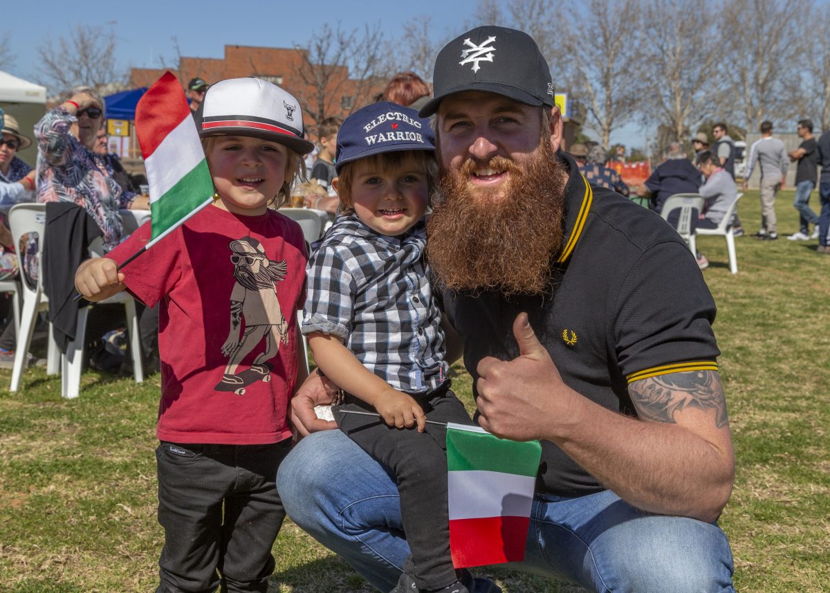 Man and two children with Italian flags
