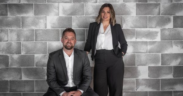 Perfect timing for real estate couple to wave the Raine & Horne Commercial flag in Canberra