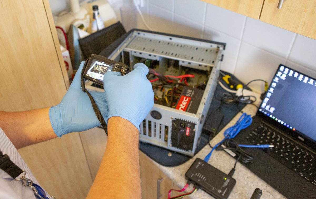 Person photographing IT equipment