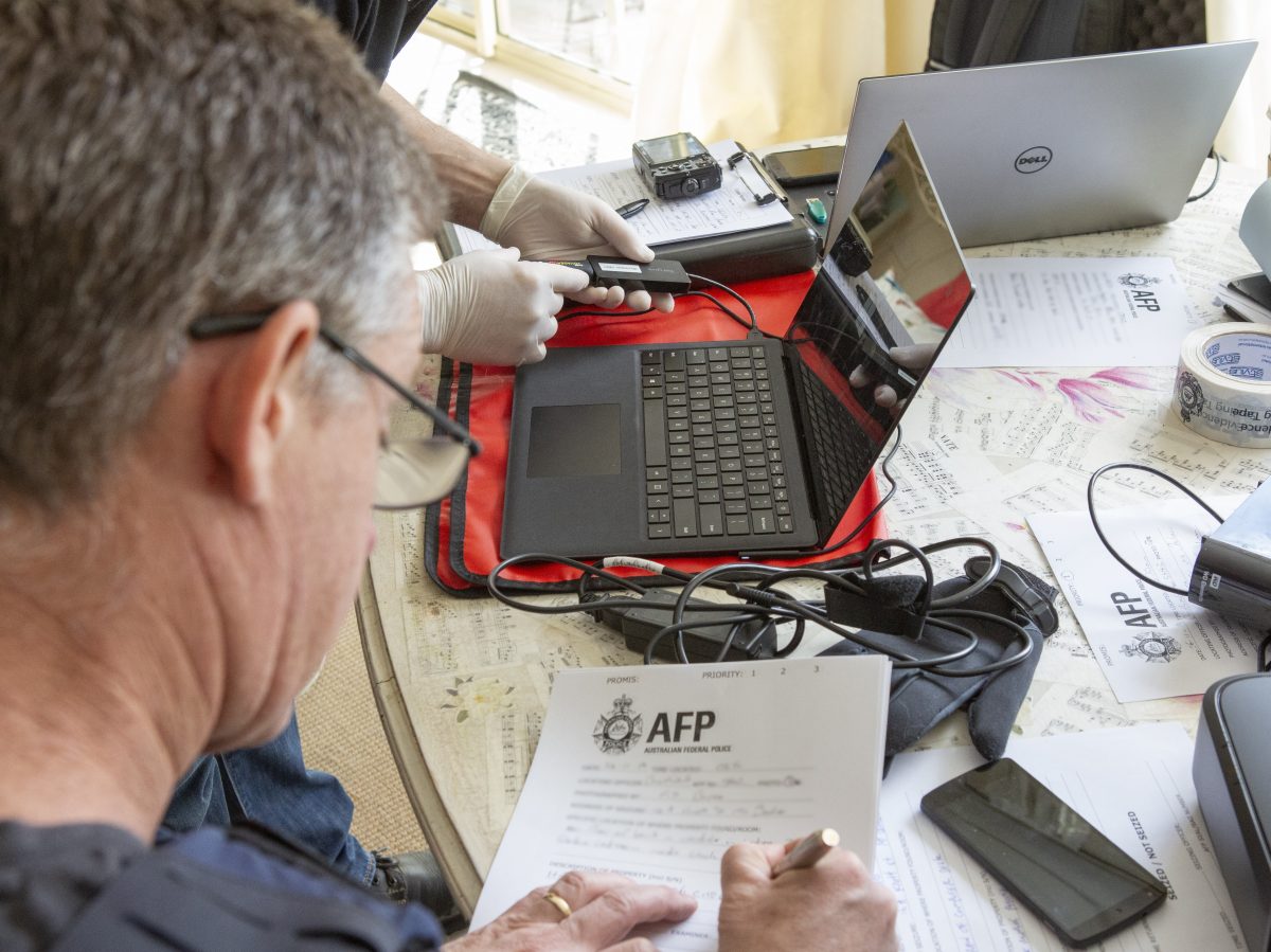 Person writing on AFP document