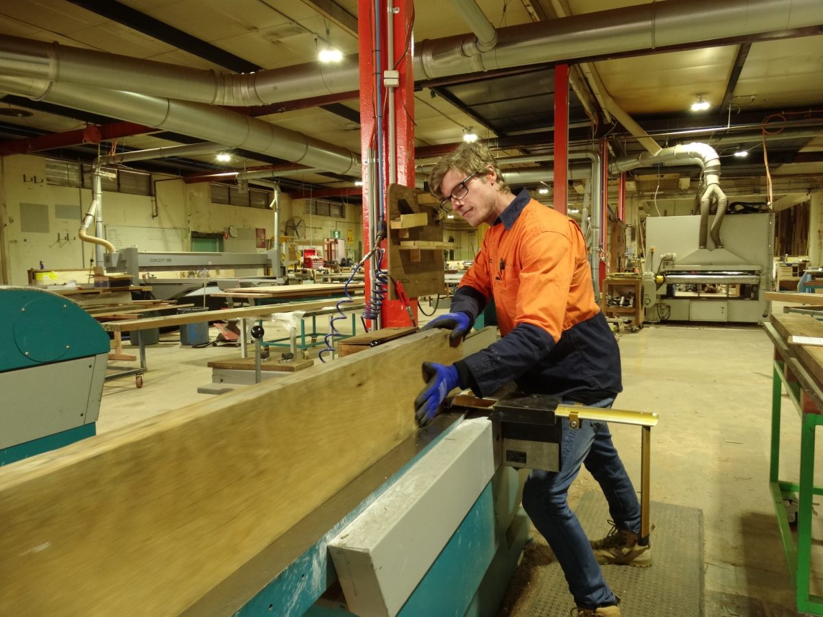 Builder cutting timber