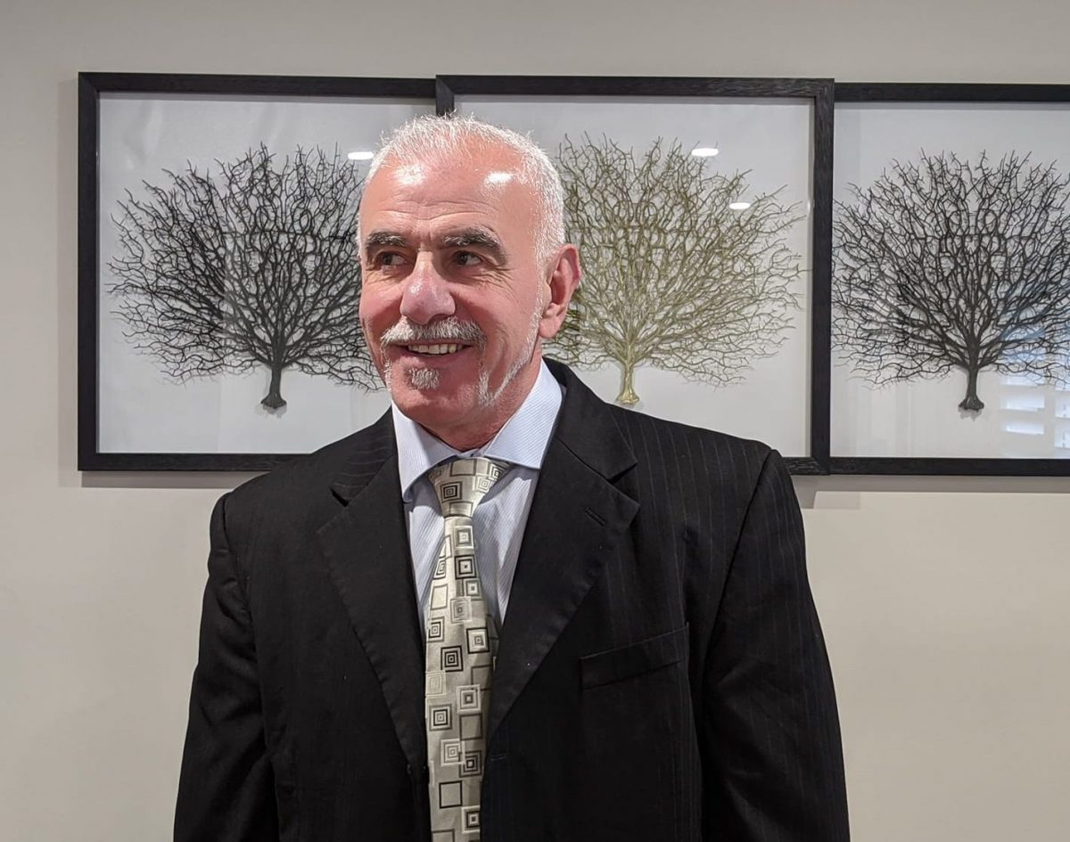 Man with white hair in a suit