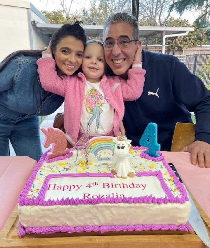 birthday girl and cake with parents