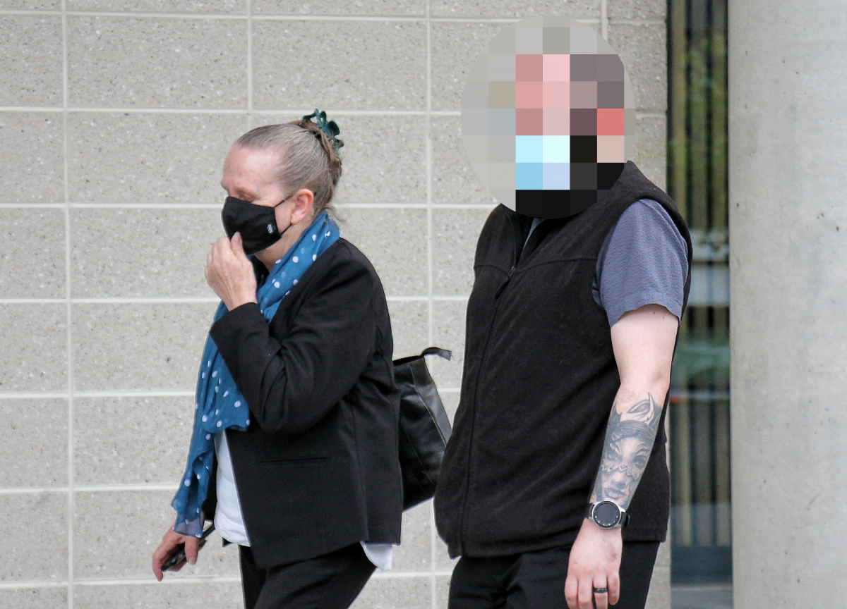 Woman with mask walking outside court