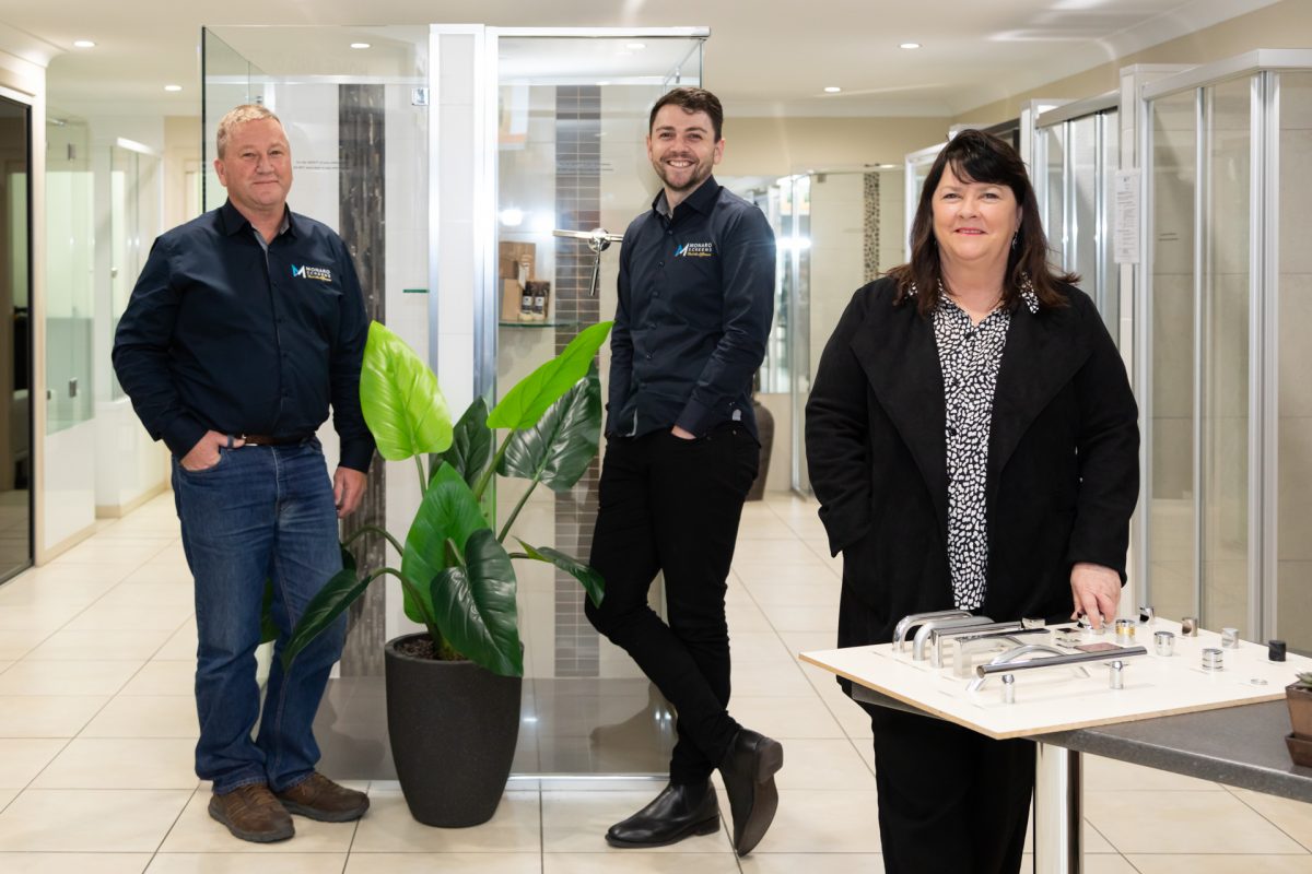 David, Ben and Deirdre Byatt stand in the Monaro Screens showroom