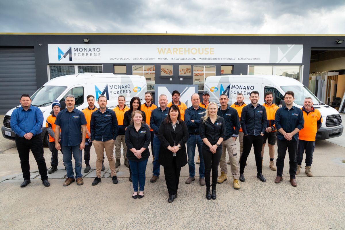 The Monaro Screen team lined up in front of the warehouse