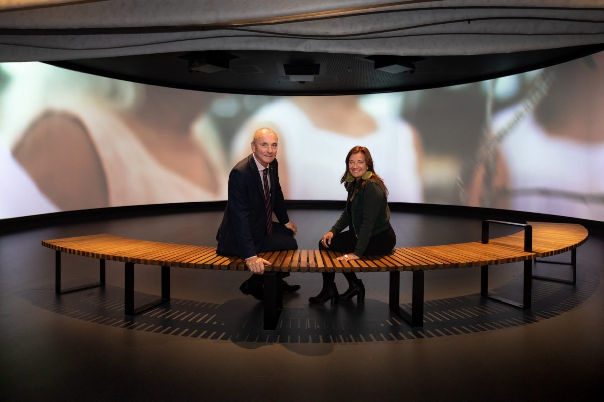 Man and woman in front of screen