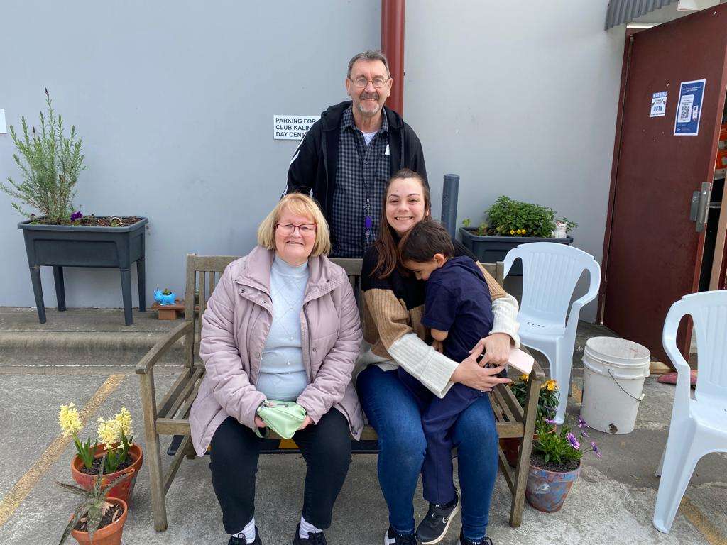 Three people sitting on a bench