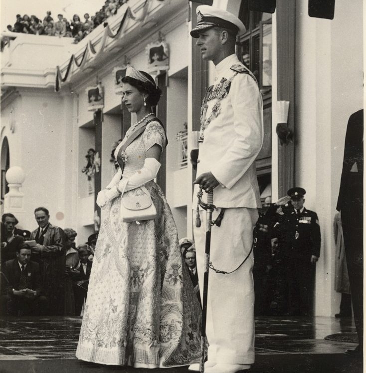 The Queen and Prince Philip standing on steps