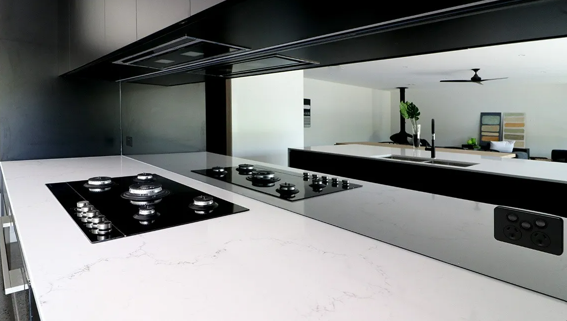 kitchen with glass splashback and marble bench