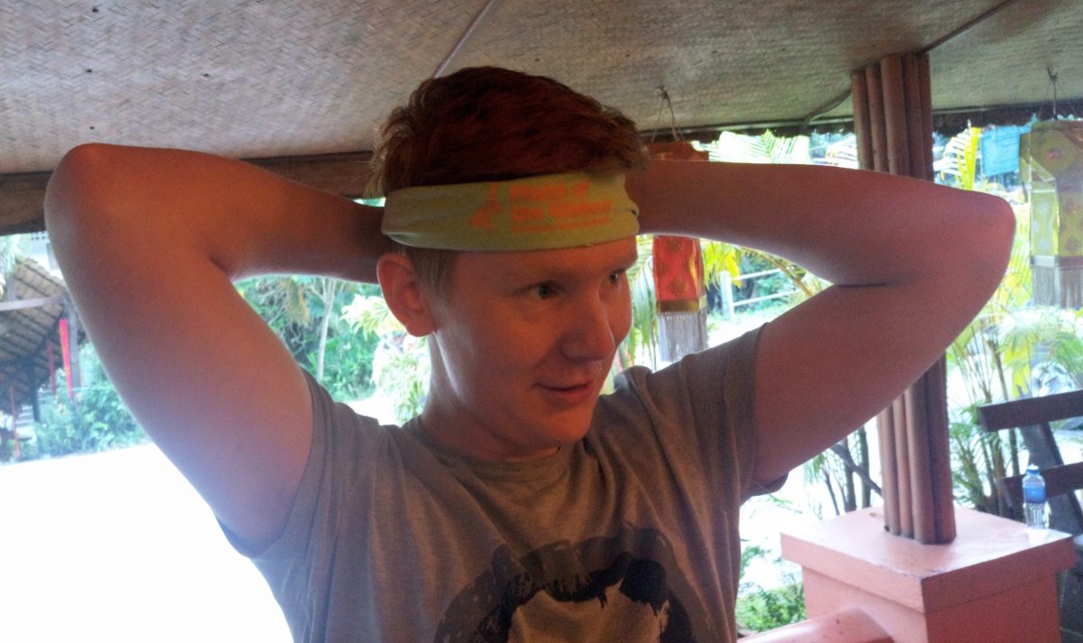 Matthew McLuckie putting on a bandana