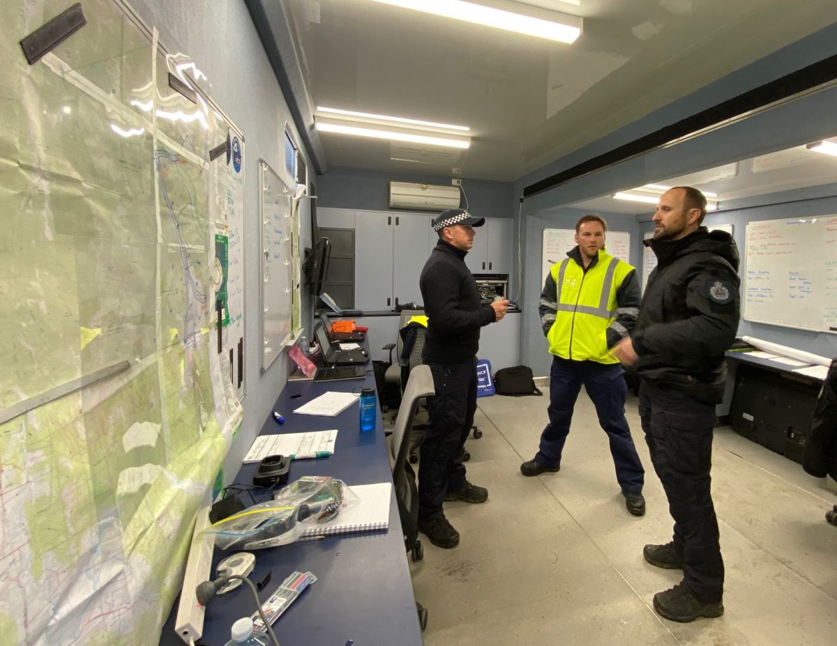 Three men in emergency services command post