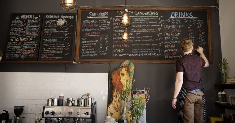 Man writing on menu board