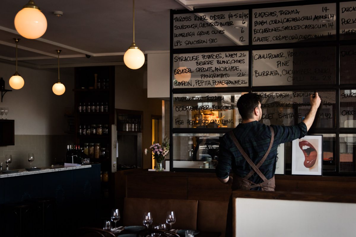 Man writing on menu