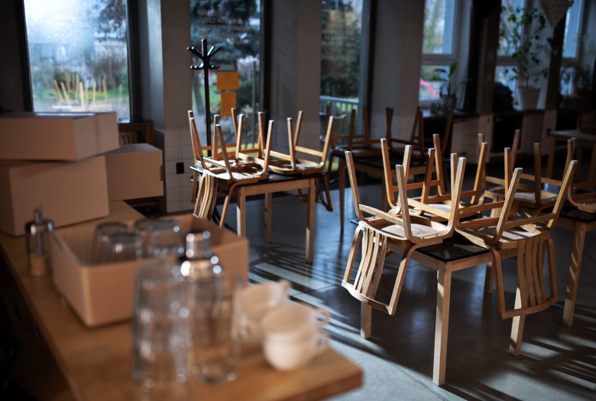 empty, closed cafe with chairs on tables