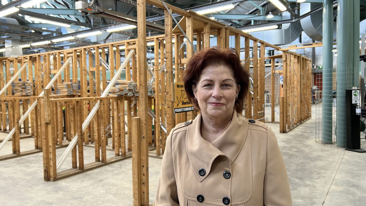 woman in front of timber frames