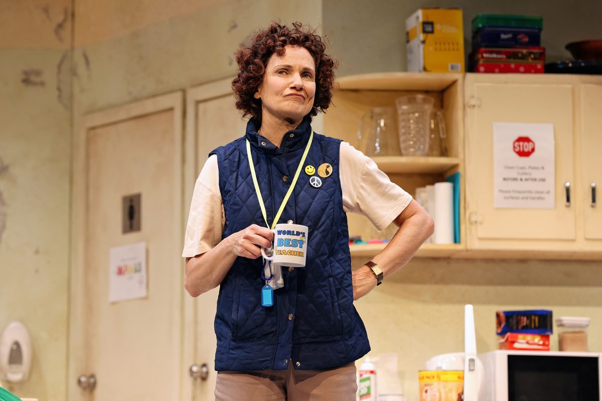 person on stage holding a mug