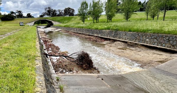 Flooding rain rips apart 60 metres of concrete in Curtin stormwater channel