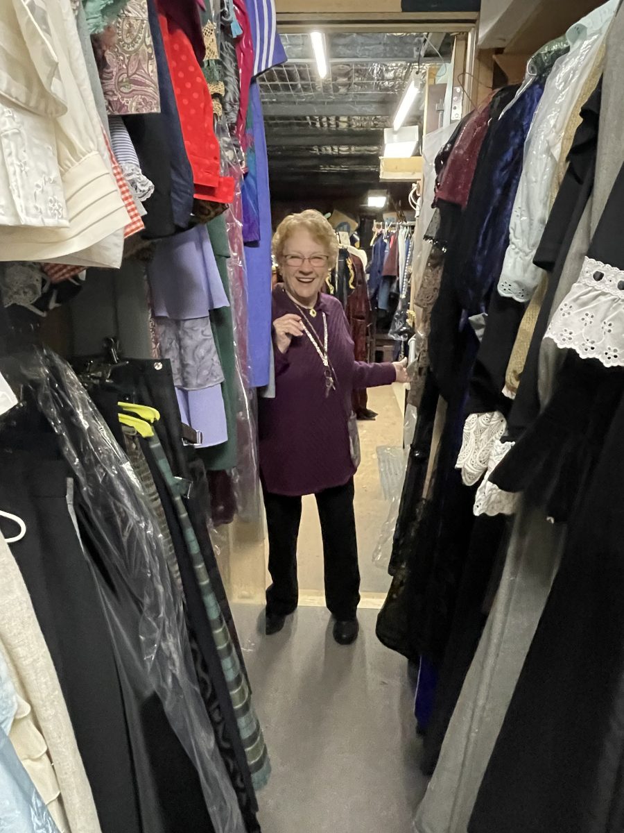 Woman in racks of clothes