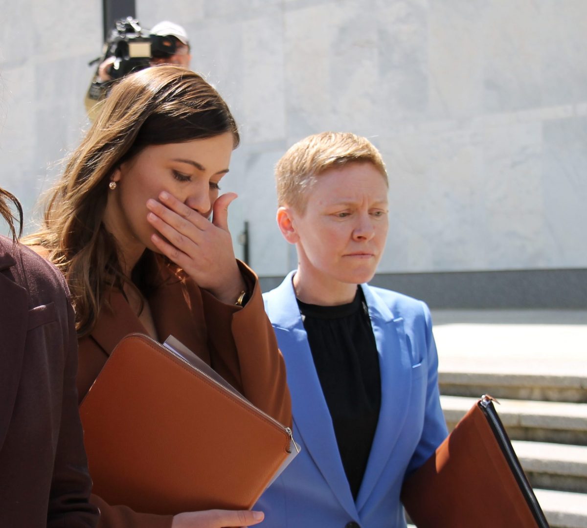 Two women leaving court