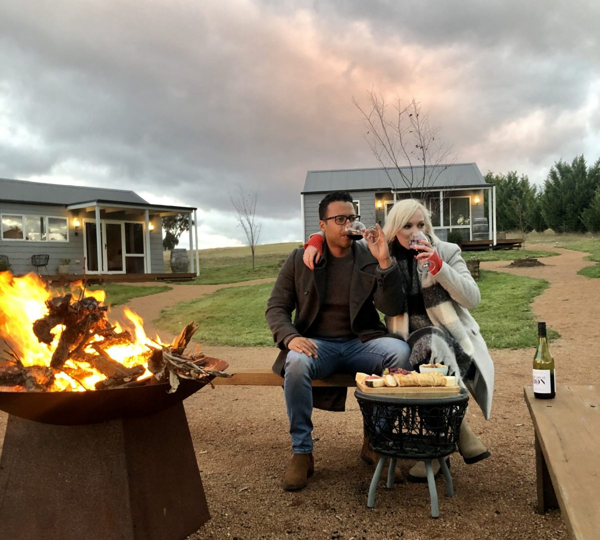 Couple drink wine at Tallagandra Hill accommodation