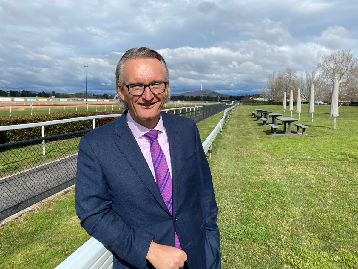 Man in suit at race track