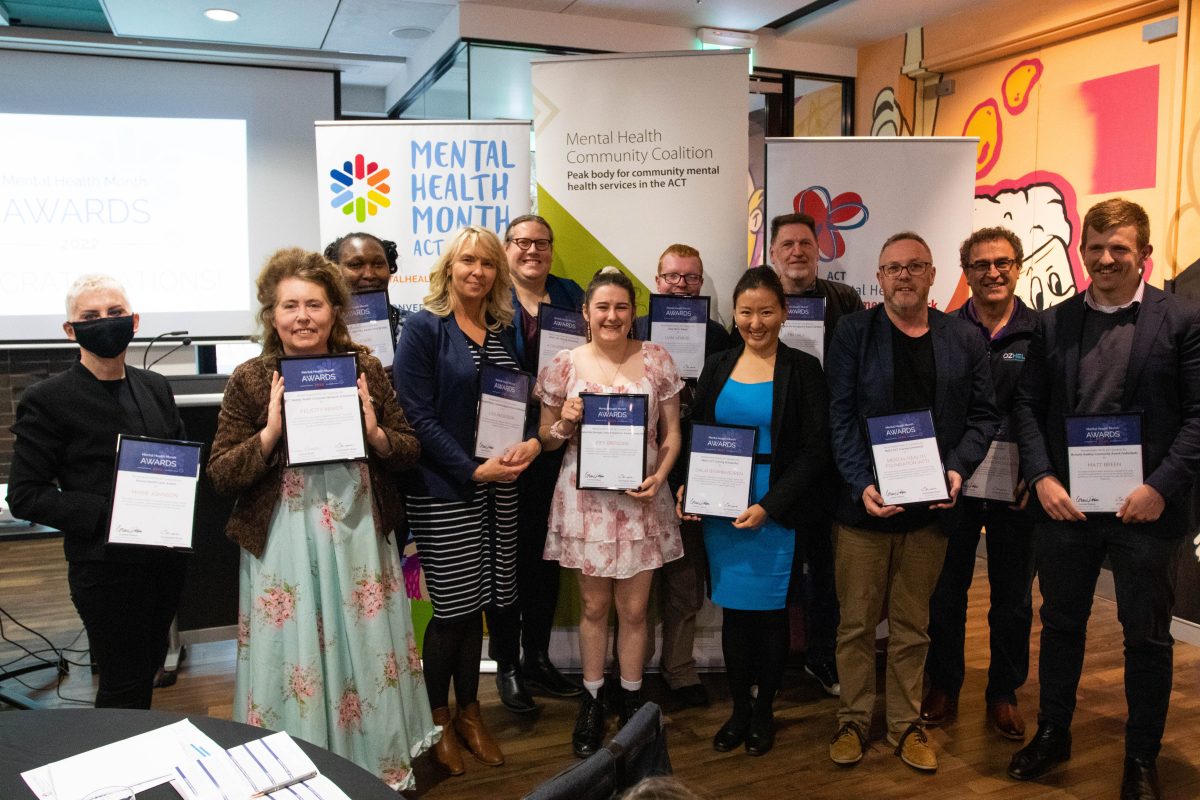 A group of people holding awards