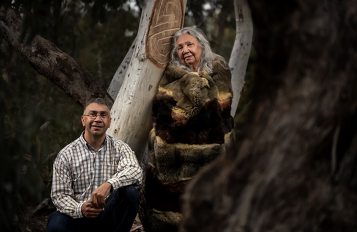 man and woman with scarred tree