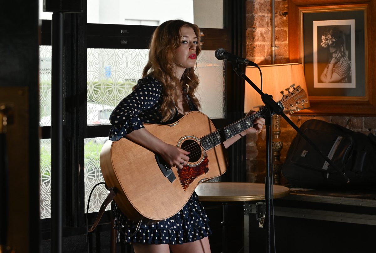 Woman on stage with guitar