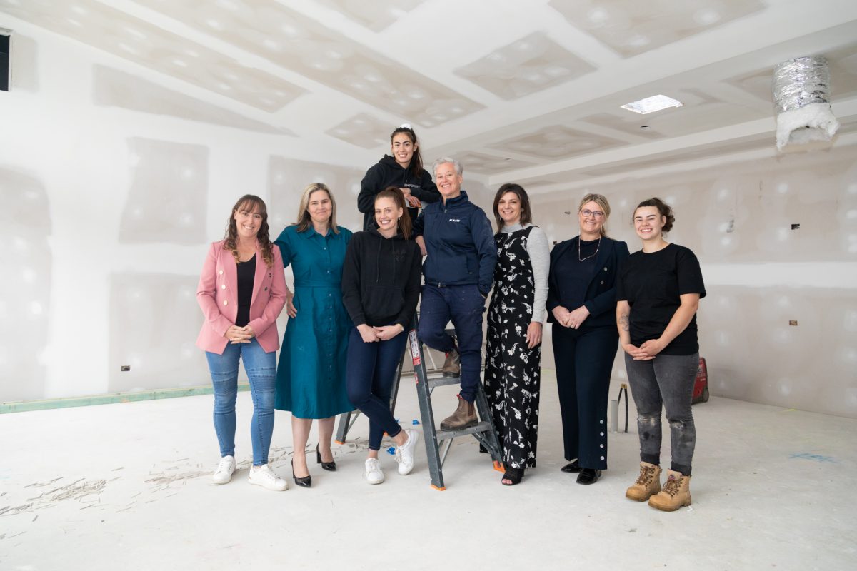 An all female team of real estate agents with some of the building team at Strathnairn charity house