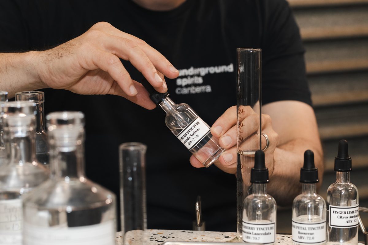 Tinctures being measured out in a beaker from drop bottle.