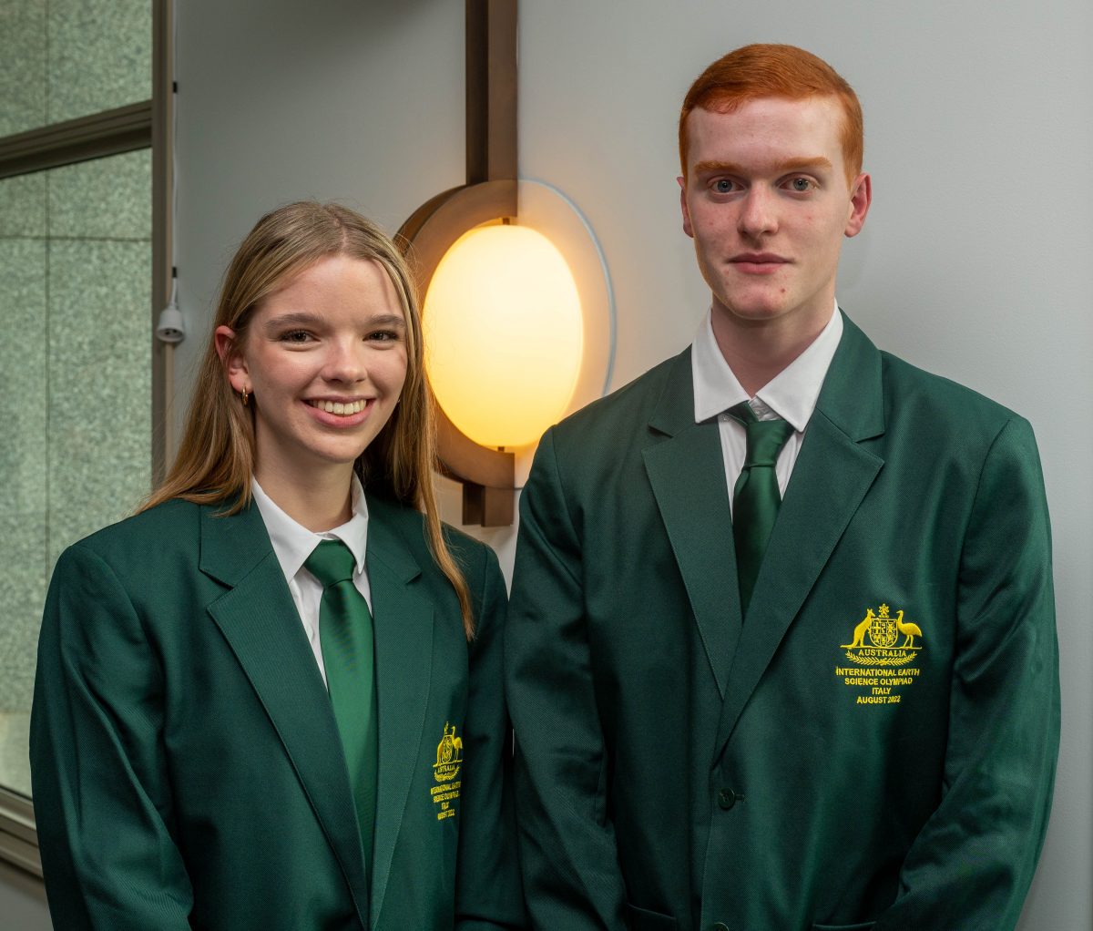 Female and male students wearing blazers